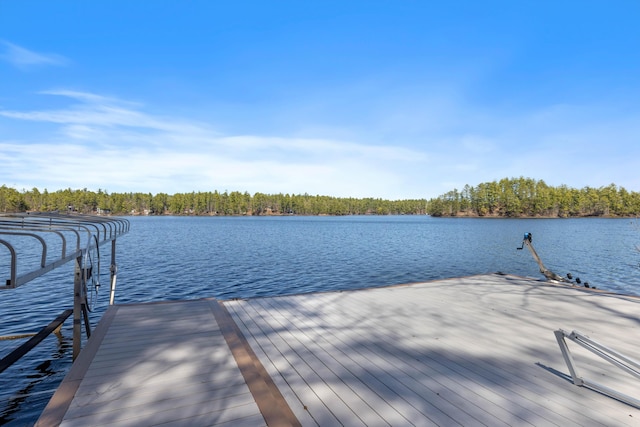 dock area featuring a water view and a forest view