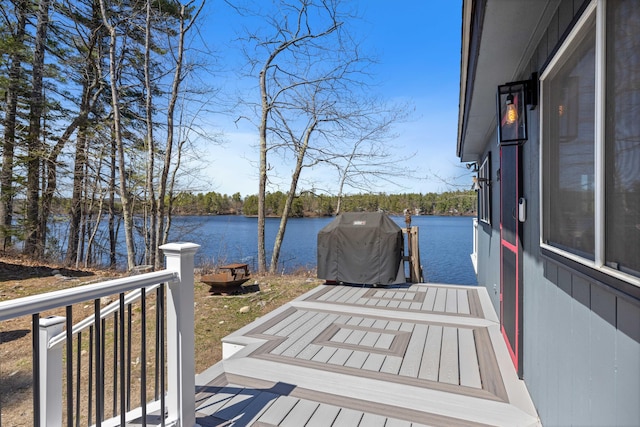 dock area featuring a deck with water view
