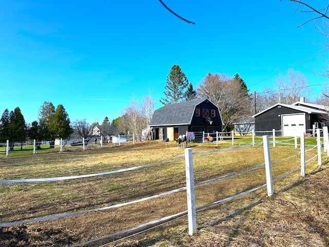 6 Ridge Rd, Corinth, ME 04427 - view of front of home featuring a gambrel roof, an outdoor structure, fence, a garage, and a barn