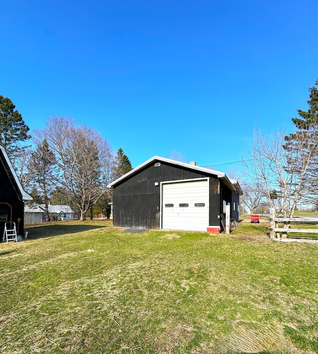 6 Ridge Rd, Corinth, ME 04427 - view of property exterior with an outdoor structure, a detached garage, and a lawn