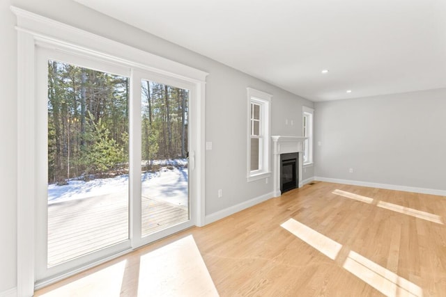 193 Stewart Dr Unit 0, Scarborough, ME 04074 - unfurnished living room with a glass covered fireplace, baseboards, recessed lighting, and light wood-style flooring