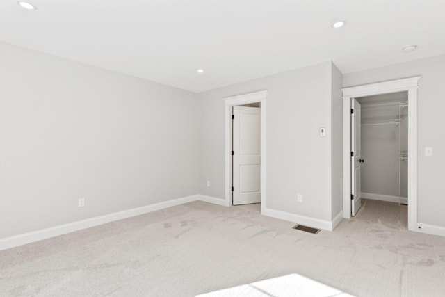 193 Stewart Dr Unit 0, Scarborough, ME 04074 - unfurnished bedroom with light colored carpet, a walk in closet, recessed lighting, baseboards, and visible vents