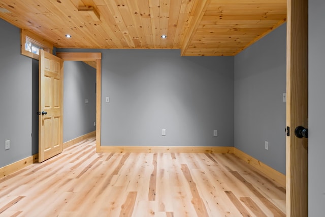 empty room with wood ceiling, wood finished floors, recessed lighting, and baseboards