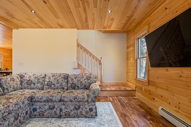 living room featuring a baseboard radiator, wooden walls, and wooden ceiling