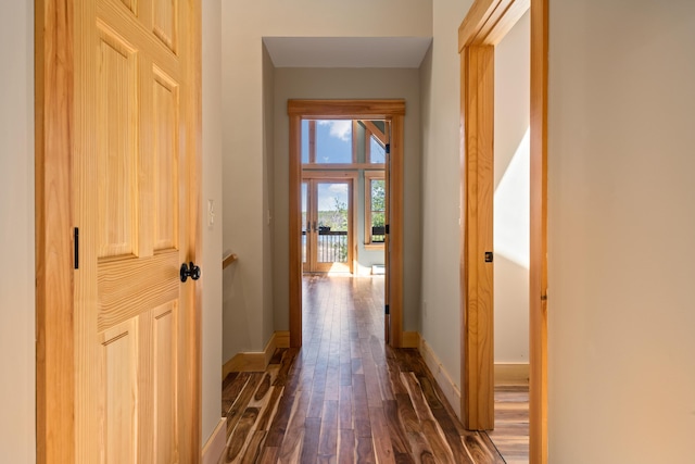 hallway with dark wood-style floors and baseboards