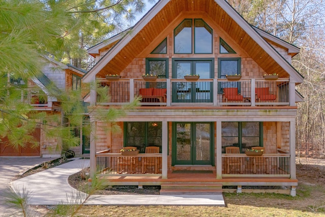 back of house featuring a balcony and french doors
