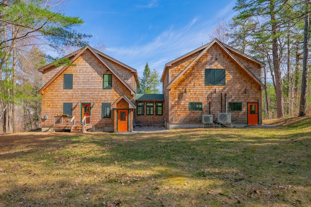 rear view of property featuring a yard and ac unit