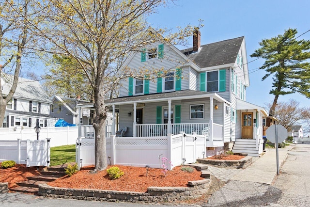 15 Longwood Ave, Old Orchard Beach, ME 04064 - victorian house with covered porch, a chimney, and fence private yard