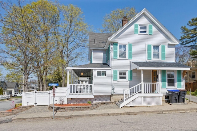 15 Longwood Ave, Old Orchard Beach, ME 04064 - view of front of home with covered porch, a chimney, a gate, and roof with shingles