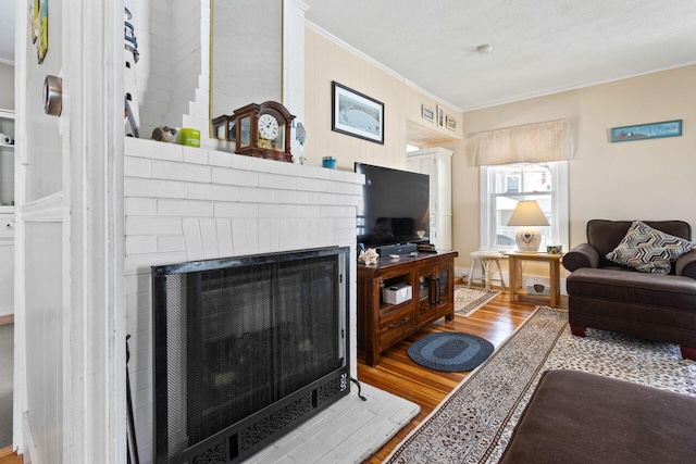 15 Longwood Ave, Old Orchard Beach, ME 04064 - living room with ornamental molding, a fireplace, and wood finished floors