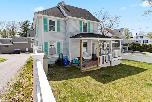 15 Longwood Ave, Old Orchard Beach, ME 04064 - view of front of home featuring fence, a porch, and a front lawn