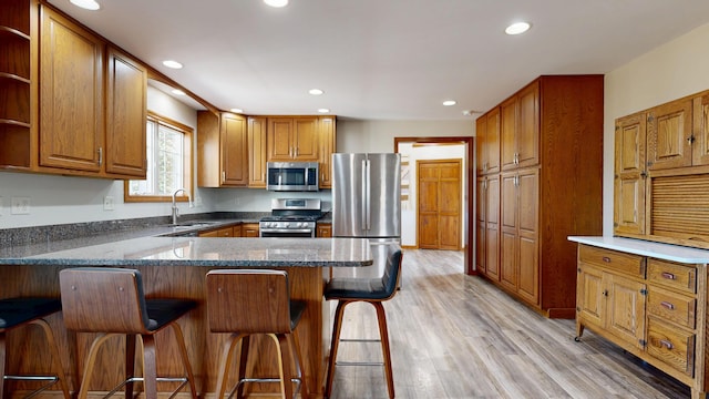 kitchen with open shelves, a peninsula, recessed lighting, a sink, and appliances with stainless steel finishes