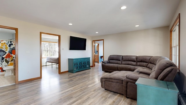 living room with recessed lighting, light wood-style flooring, and baseboards