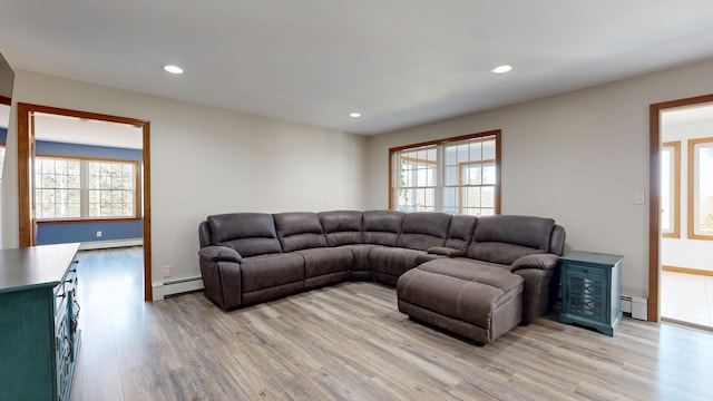 living room featuring recessed lighting, light wood-style flooring, a baseboard heating unit, and baseboard heating