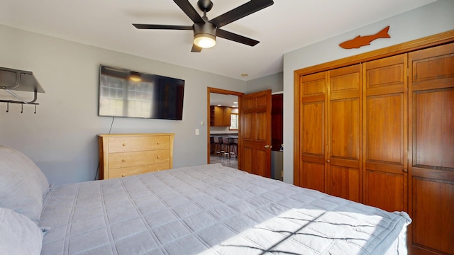 bedroom with ceiling fan and a closet