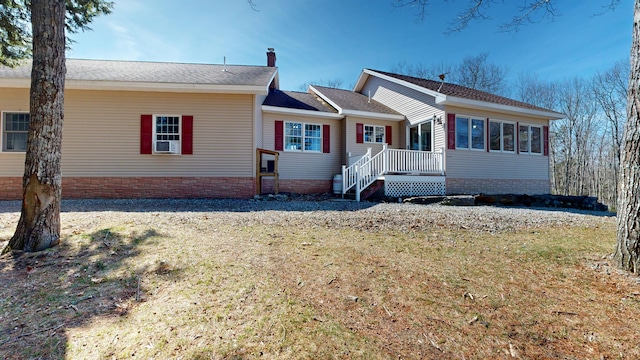 view of front of home with a chimney and a front lawn