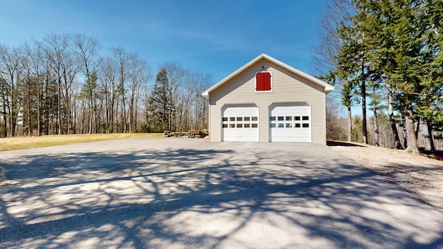 view of side of property with a garage and an outbuilding