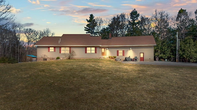 view of front of house featuring a yard and a chimney