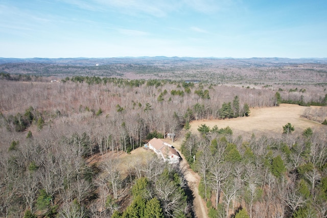birds eye view of property featuring a forest view