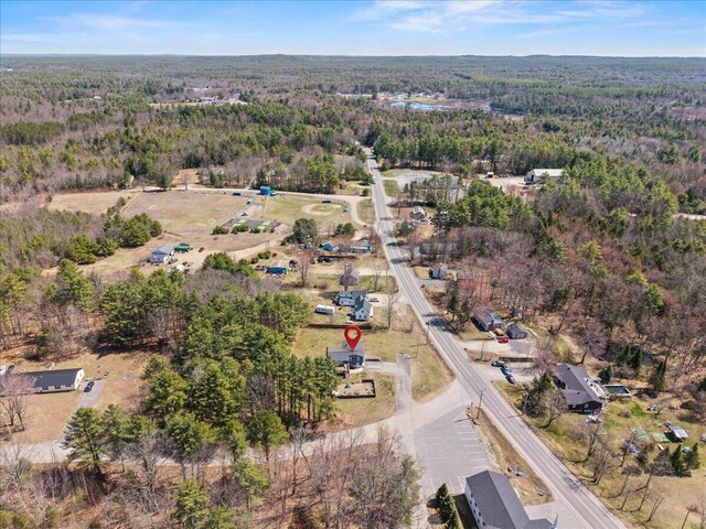birds eye view of property with a wooded view