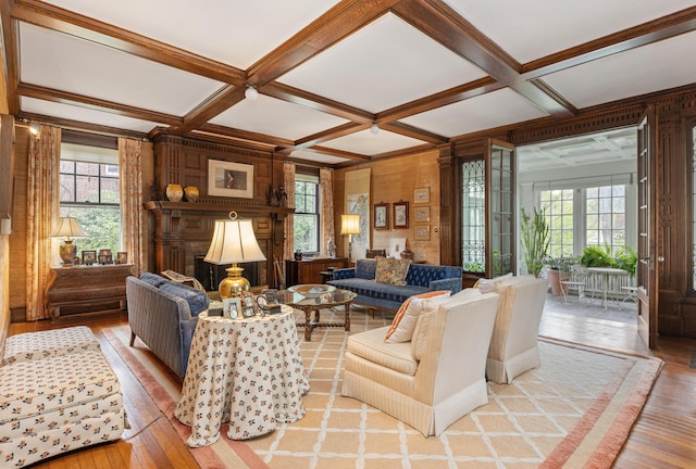 70 Carroll St, Portland, ME 04102 - living room featuring light wood-style flooring, plenty of natural light, coffered ceiling, beam ceiling, and wood walls