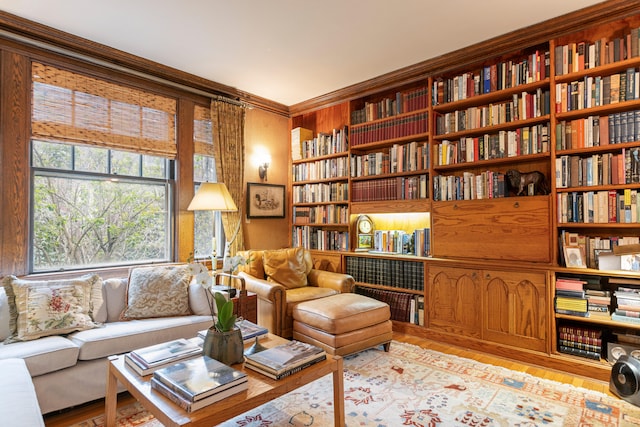 70 Carroll St, Portland, ME 04102 - sitting room featuring wall of books, wood finished floors, built in features, and crown molding