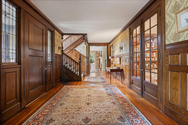 70 Carroll St, Portland, ME 04102 - foyer entrance featuring wood-type flooring, wallpapered walls, and stairway