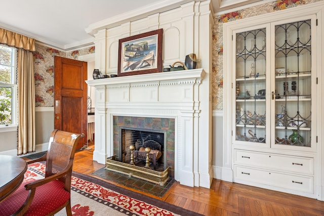 70 Carroll St, Portland, ME 04102 - living room with wallpapered walls, crown molding, baseboards, wainscoting, and a tiled fireplace