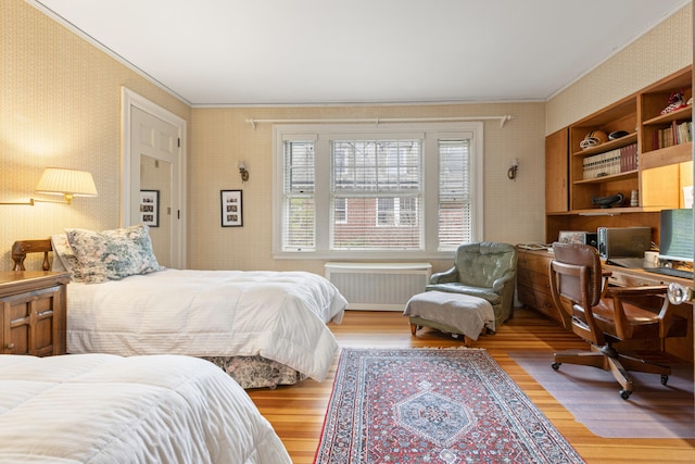 70 Carroll St, Portland, ME 04102 - bedroom with radiator heating unit, wallpapered walls, wood finished floors, an office area, and ornamental molding