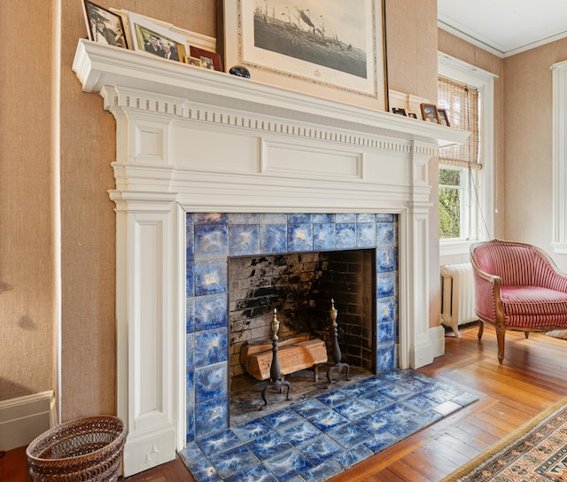 70 Carroll St, Portland, ME 04102 - detailed view of wood finished floors, a tiled fireplace, and radiator heating unit