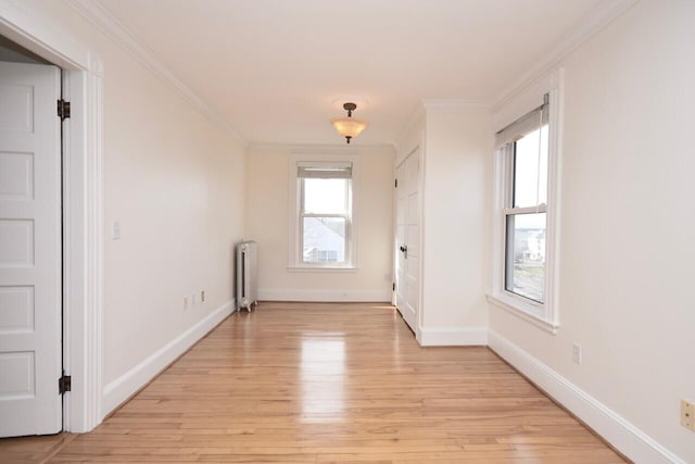 105 N St Unit 3, Portland, ME 04101 - unfurnished room featuring radiator heating unit, ornamental molding, light wood-style flooring, and plenty of natural light