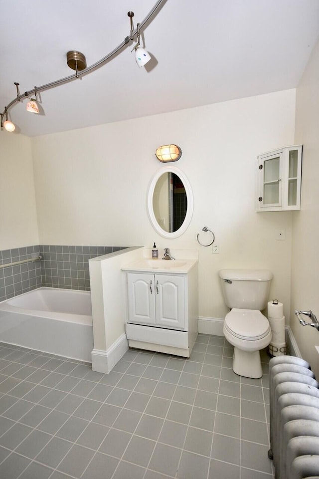 105 N St Unit 3, Portland, ME 04101 - bathroom with radiator heating unit, tile patterned flooring, a garden tub, baseboards, and toilet