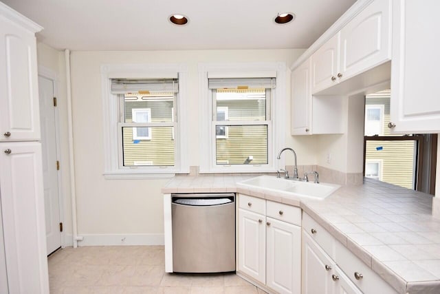 105 N St Unit 3, Portland, ME 04101 - kitchen with dishwasher, a sink, tile countertops, white cabinets, and baseboards