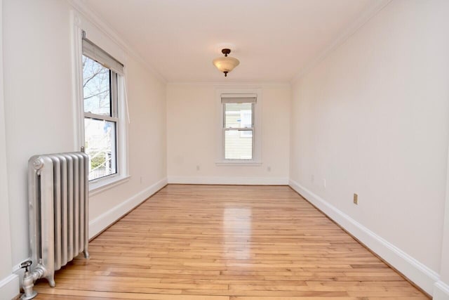 105 N St Unit 3, Portland, ME 04101 - spare room featuring radiator, light wood-type flooring, ornamental molding, and baseboards