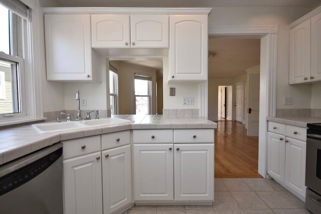 105 N St Unit 3, Portland, ME 04101 - kitchen featuring dishwasher, a sink, white cabinets, and tile counters