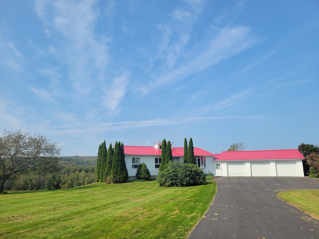 420 Main St, Canaan, ME 04924 - view of front of property with a garage, a front lawn, aphalt driveway, and metal roof