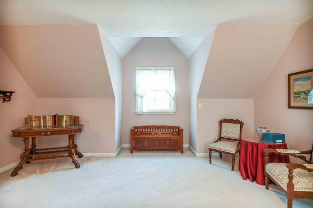 sitting room featuring carpet flooring, baseboards, and lofted ceiling