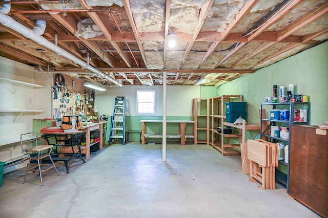 below grade area featuring a workshop area and a baseboard radiator