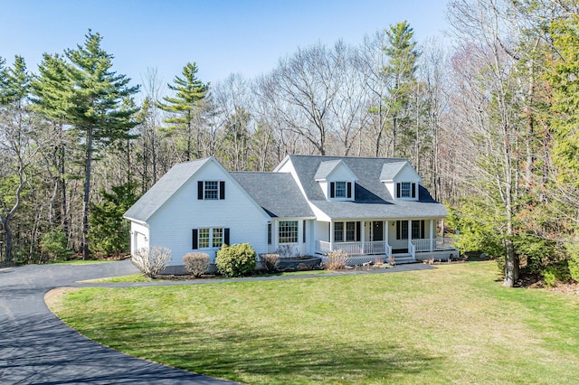 cape cod-style house featuring covered porch, a garage, aphalt driveway, and a front lawn
