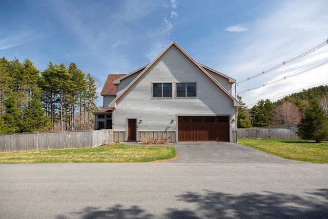 3 Bogue Chitto Ln Unit 1, Bar Harbor, ME 04609 - view of front of home featuring fence, an attached garage, a front lawn, and aphalt driveway