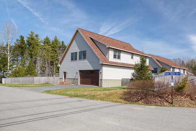 3 Bogue Chitto Ln Unit 1, Bar Harbor, ME 04609 - view of side of home featuring fence, an attached garage, and aphalt driveway