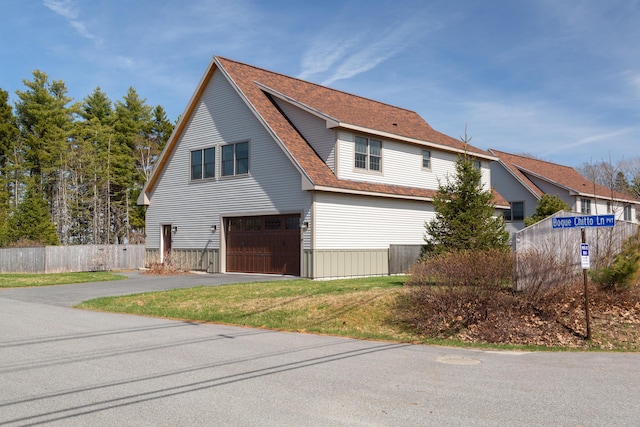 3 Bogue Chitto Ln Unit 1, Bar Harbor, ME 04609 - view of side of property with fence, an attached garage, driveway, and roof with shingles