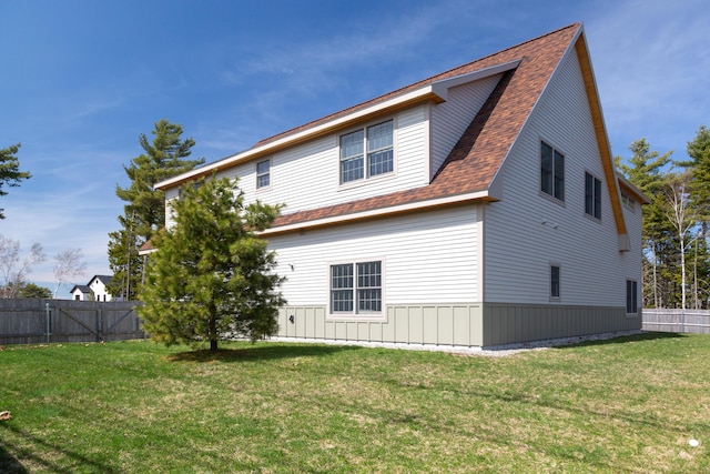3 Bogue Chitto Ln Unit 1, Bar Harbor, ME 04609 - back of property featuring fence, a shingled roof, and a yard