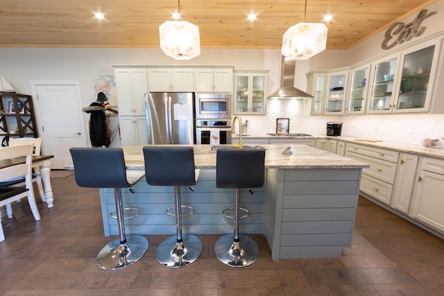 3 Bogue Chitto Ln Unit 1, Bar Harbor, ME 04609 - kitchen featuring wood ceiling, appliances with stainless steel finishes, tasteful backsplash, wall chimney exhaust hood, and an island with sink