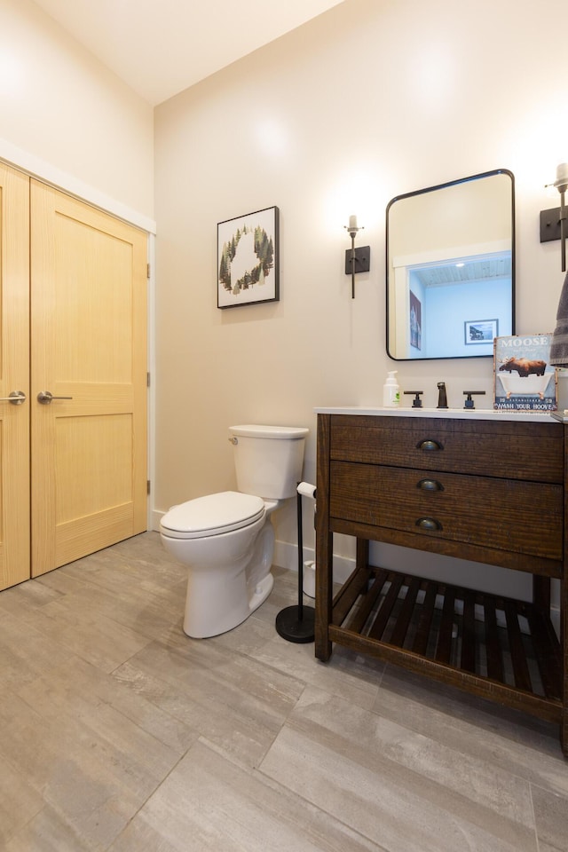3 Bogue Chitto Ln Unit 1, Bar Harbor, ME 04609 - bathroom featuring baseboards, toilet, and vanity