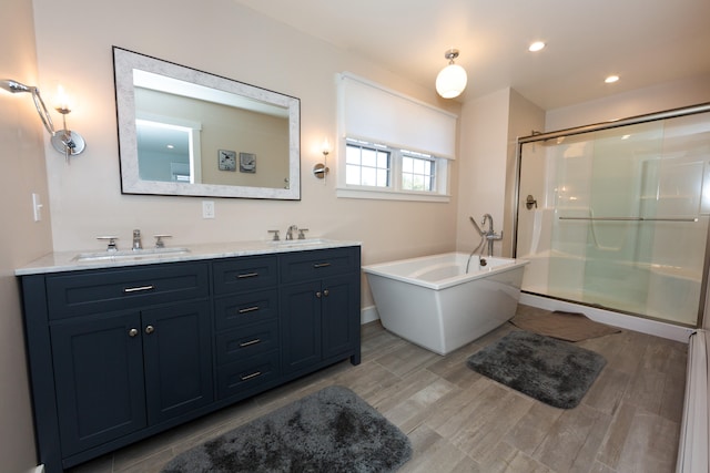 3 Bogue Chitto Ln Unit 1, Bar Harbor, ME 04609 - bathroom featuring double vanity, a sink, a freestanding tub, and a shower stall