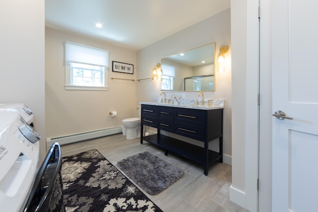 3 Bogue Chitto Ln Unit 1, Bar Harbor, ME 04609 - bathroom with toilet, double vanity, wood finished floors, an enclosed shower, and a baseboard heating unit