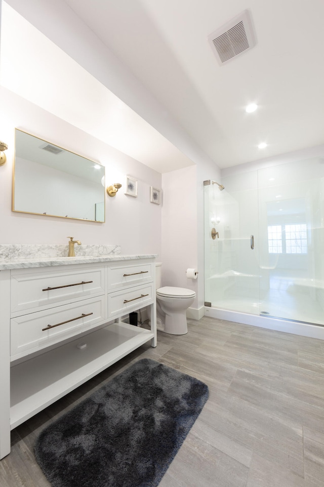3 Bogue Chitto Ln Unit 1, Bar Harbor, ME 04609 - full bath with vanity, toilet, a shower stall, wood finished floors, and visible vents