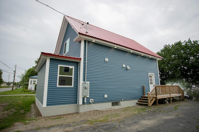 16 Main St, Bradley, ME 04411 - view of side of home with a deck and a metal roof
