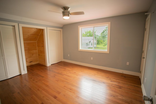 16 Main St, Bradley, ME 04411 - unfurnished bedroom featuring two closets, wood-type flooring, and a ceiling fan